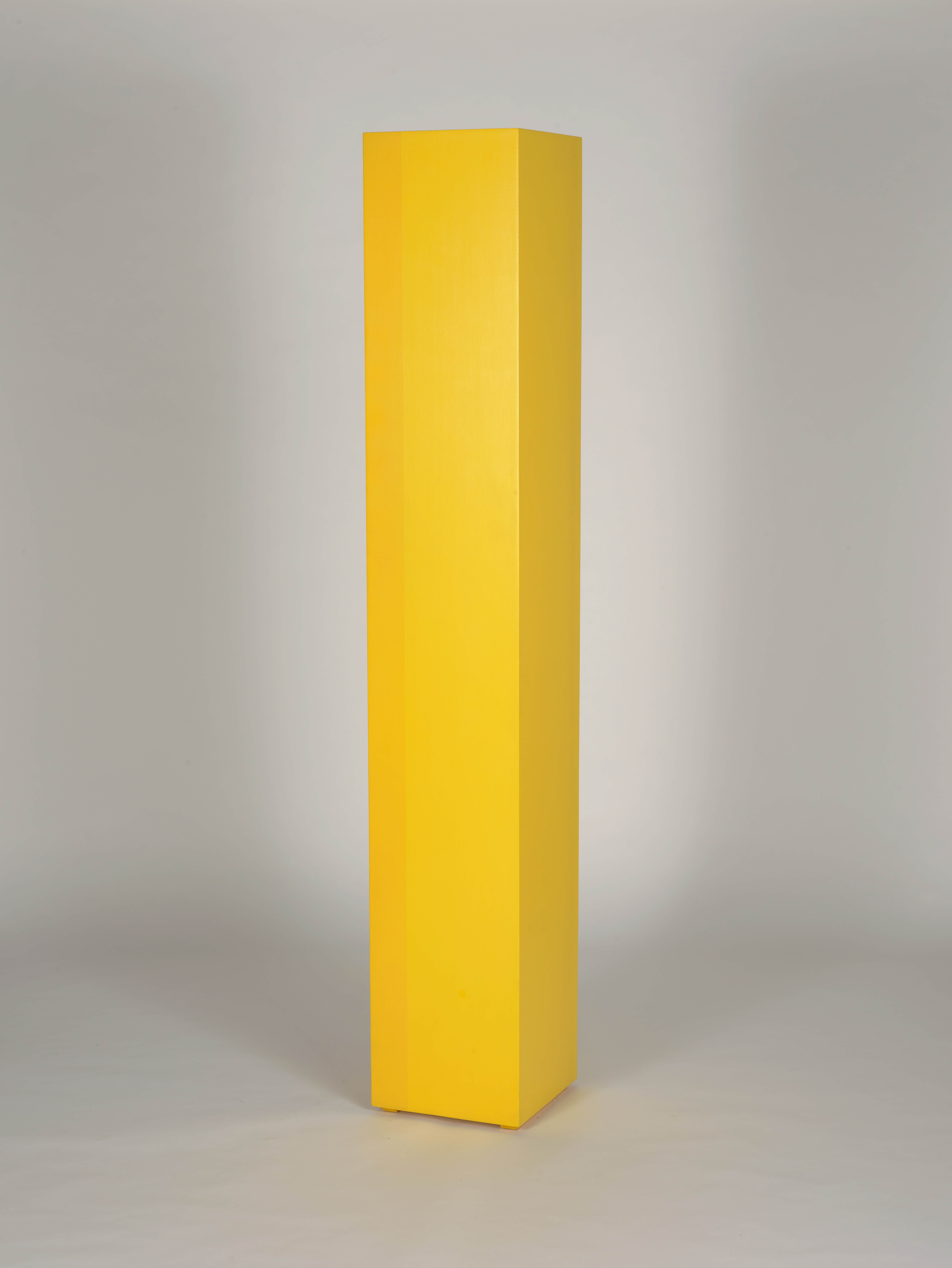 Rectangular sculpture painted in shades of yellow
