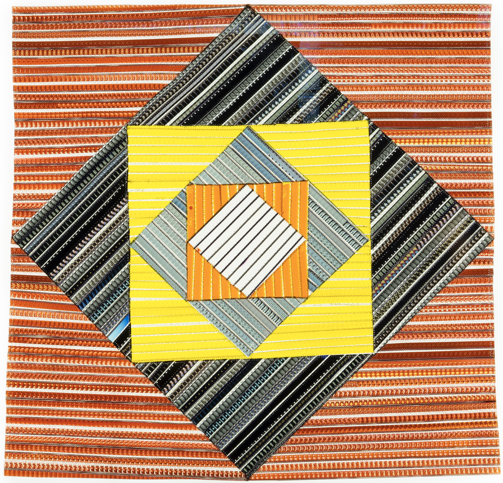 This “film quilt” on a lightbox is comprised of 16mm filmstrips sewn into a pattern evoking a quilt motif.
