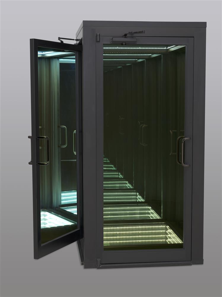 Reality Show (Black) is an infinity chamber for a single user. Resembling a phone booth with four doors, the interior chamber is lined with two-way mirrors and white LEDs on its walls, ceiling and floor. Inside, a viewer is faced with a seemingly endless self-reflection within a light vortex.
