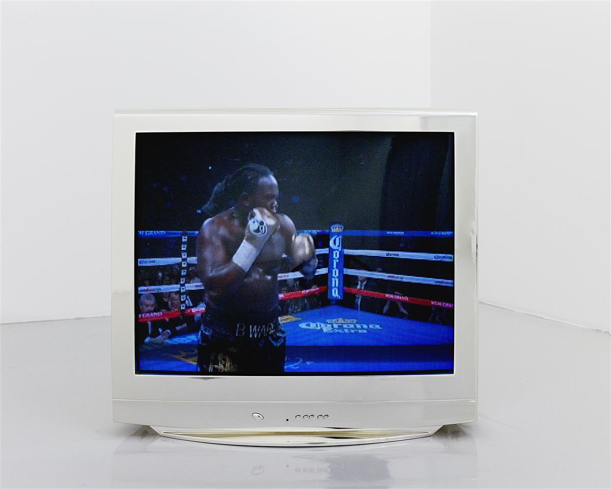 Television showing a Black man in a boxing ring