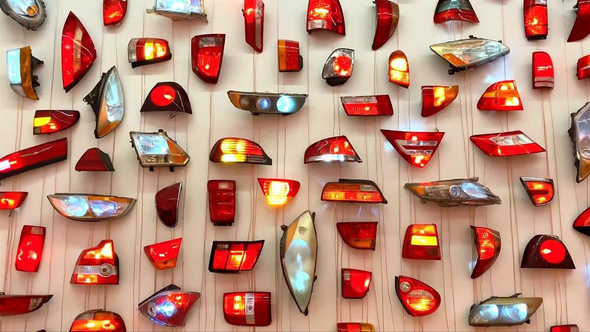 Car head and tail lights hung on a wall