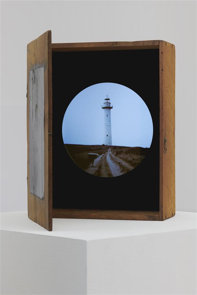 Lantern box with video screen sits on a pedestal